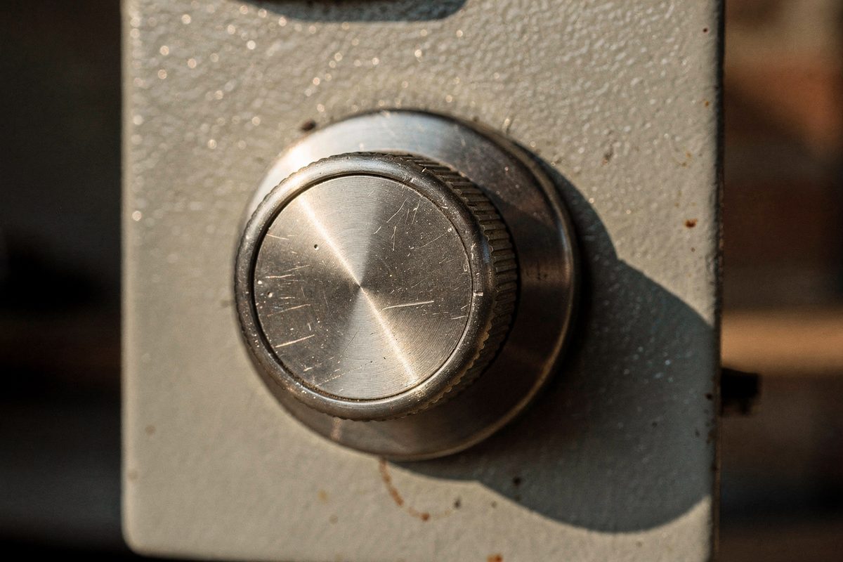 A close-up of a brushed steel combination dial on a small safe door